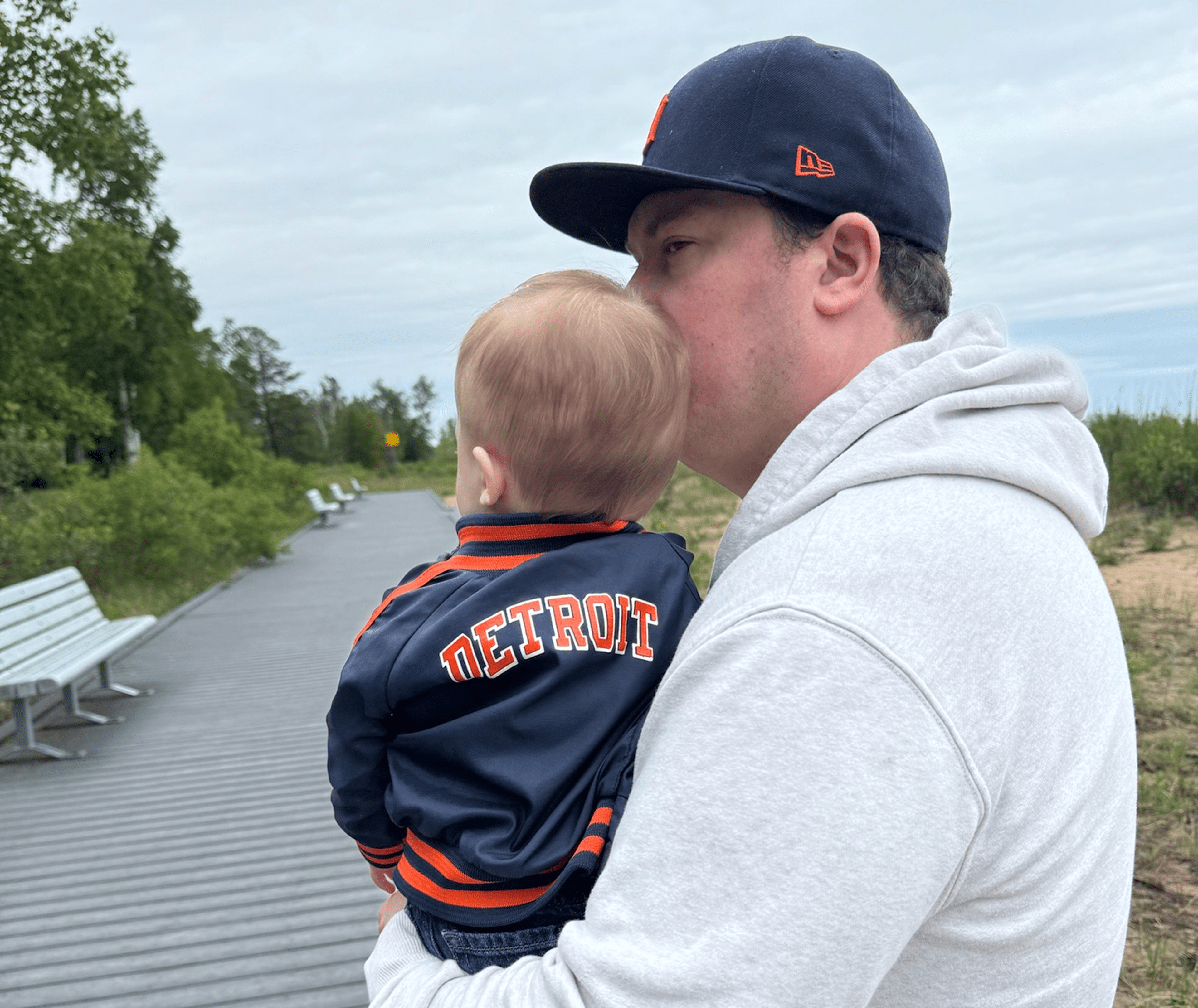 Joe Velez Holding His Son in Tigers Gear